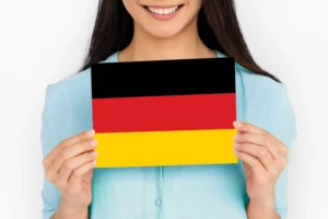 mulher segurando bandeira da Alemanha e feliz por descobrir como conseguir cidadania alemã